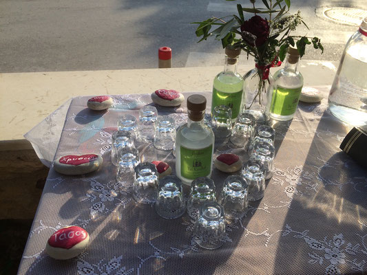 Raki decoration with glasses and hand painted stones forming a heart