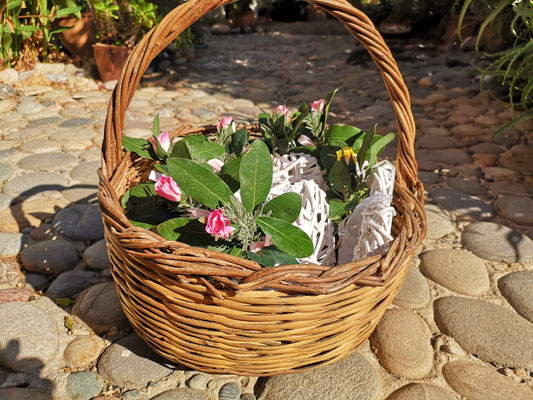 wedding decoration in basket with olive branches and roses