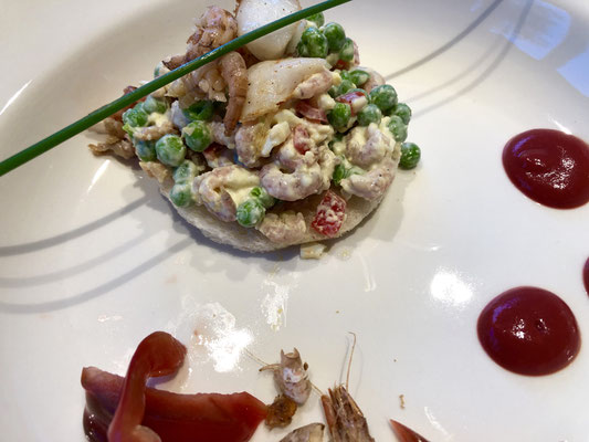 eigen creatie van tomaat-garnaal met verse doperwtjes, tomaatblokjes, grijze garnalen en eigengedraaide mayonaise op toast met stukje gebakken kabeljauw 