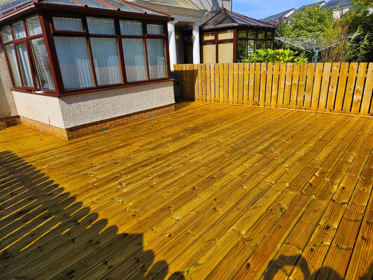 Large wooden deck in Aberdeen garden fitted around conservatory – professional residential decking installation