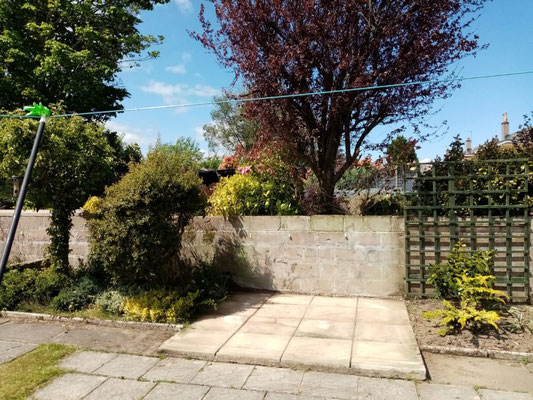 Small laid patio serving as a shed base – professional garden paving installation
