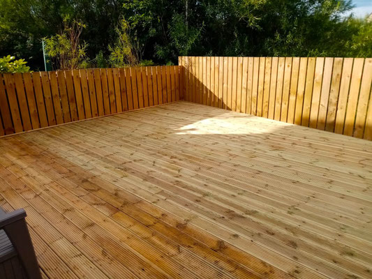 Large wooden garden deck in Aberdeen surrounded by new fencing – professional landscaping and decking installation