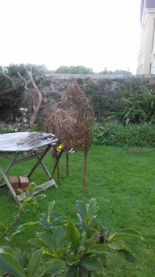half life-sized willow horse standing by garden table
