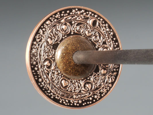Handspindel aus Münze