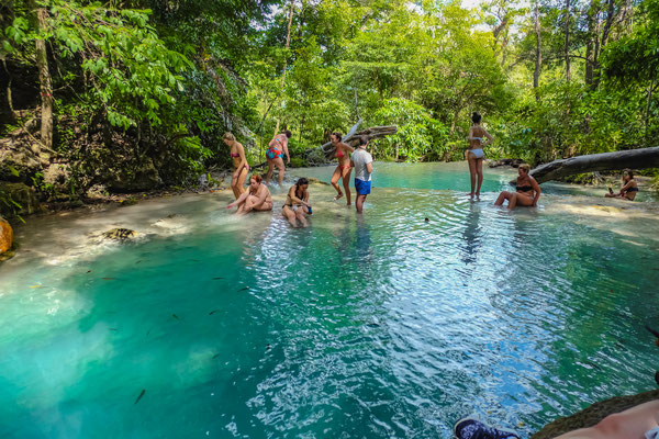Baden Sie in einem Wasserfallpool im Erawan Nationalpark