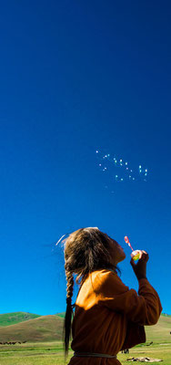 Ajdana blows soap bubbles