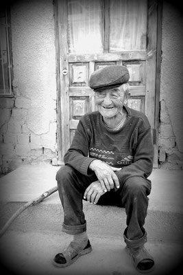 Kochkor, Kirgistan - Mr. Saadatbek sitting in front of his house