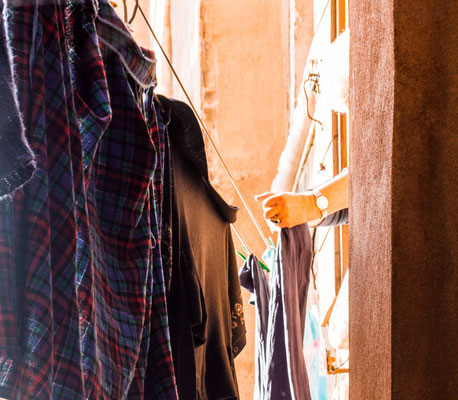 A woman hangs up laundry