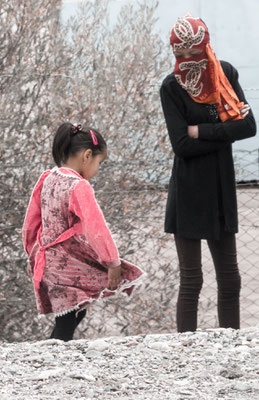 The girl shows her mother her pretty dress. Murghab, Gorno-Badakhshan Autonomus Region, Tajikistan