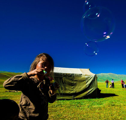 Perizat blows shimmering soap bubbles