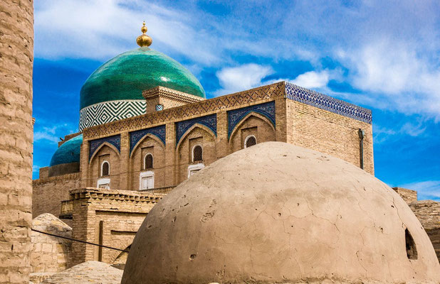 A beautiful emerald green dome topped with a gleaming gold orb marks the tomb of Pakhlavan Mahmoud - the holiest site in Khiva