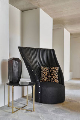 Nevada armchair designed by Luca Tornaghi for Roberto Cavalli Home, dark upholstered version showing the graphic depth of the quilting pattern across the surface