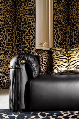 Malawi sofa by Luca Tornaghi for Roberto Cavalli Home, detail of armrest with leather upholstery, fringe and gold metal insert