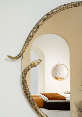 Morelia Mirror designed by Luca Tornaghi for Roberto Cavalli Home Interiors, where a sculptural serpent frame transforms reflection into a fluid ornamental presence.