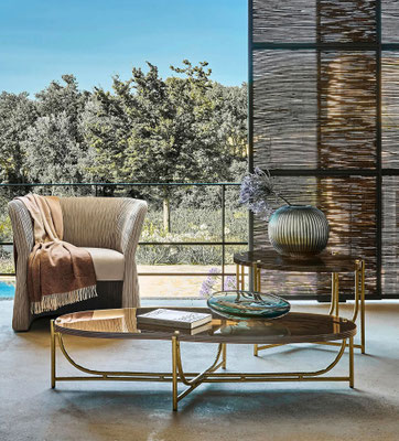 Tahoe coffee table by Luca Tornaghi for Roberto Cavalli Home, with a sculptural metal base and a fluidly shaped glass top