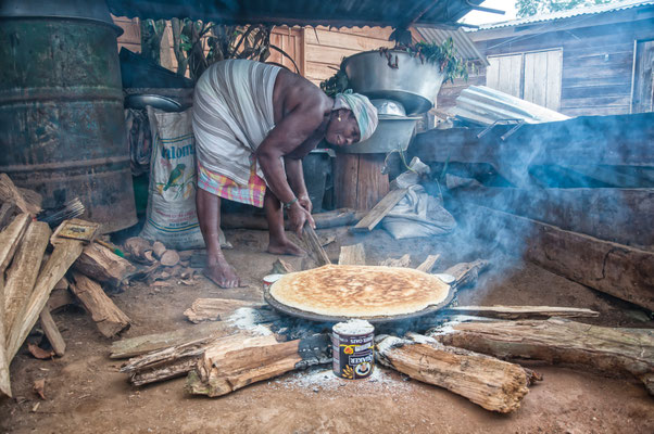 Saramaccan woman baking cassave bread (parakoranti) the traditional way