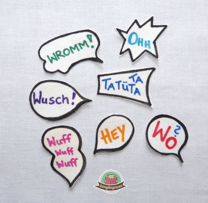 die Teile ausschneiden und an geeigneter Stelle aufbügeln und mit schwarzem Garn aufnähen