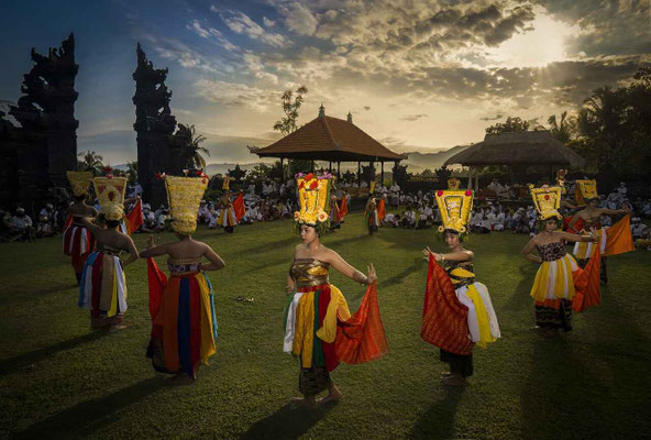 Another group of dancers moving in harmony before a temple entrance.