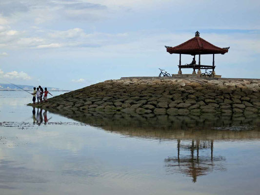 Fishing by a gazebo along Sanur’s calm shore