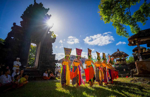 Elegant dancers performing in front of a temple gate, blending grace and ritual.