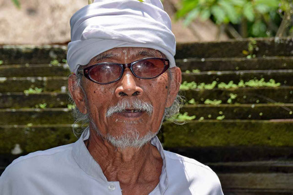 Elderly man in traditional white ceremonial attire