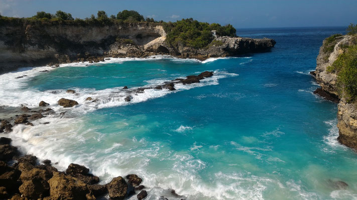 Turquoise waters tumbling into a secluded rocky cove in Nusa Lembongan
