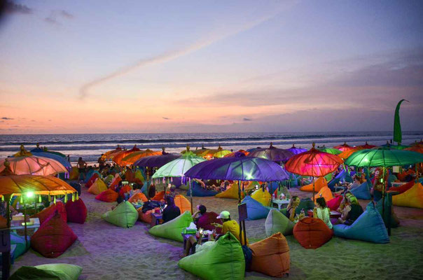 Bright parasols decorating the sandy beach at a Seminyak beach club.