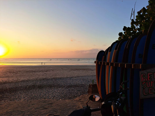 Surfboards lined up on the sands of Kuta, waiting for the next wave riders.