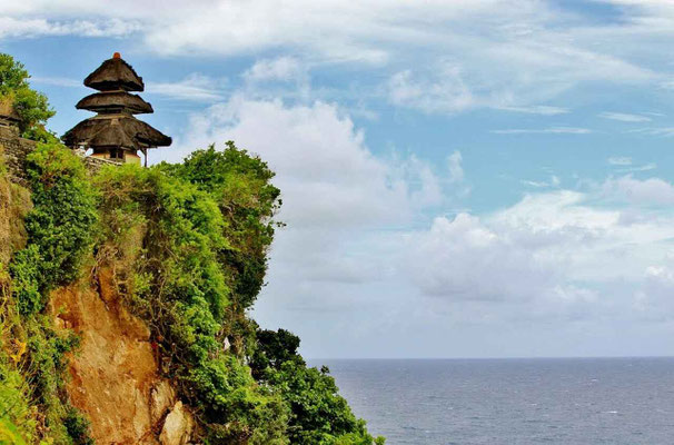 Uluwatu Temple dramatically perched on its towering cliff above the ocean.
