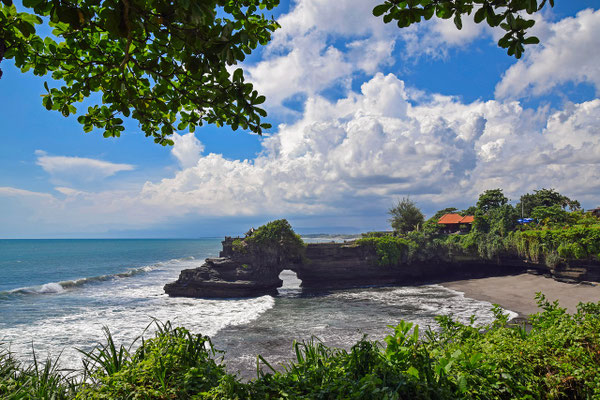 The iconic Tanah Lot temple standing strong above the ocean waves.