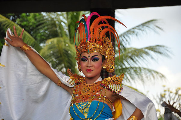 A theatrical performer in full regalia, striking a dramatic pose.