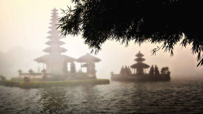Morning mist drifting over Lake Bratan with Pura Ulun Danu Bratan rising from the water.