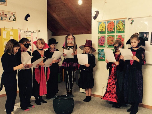 Children performing a creative storytelling activity during a Custom Kids English class.
