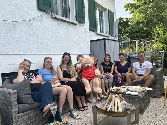 The Custom Kids teaching team celebrating together outdoors.