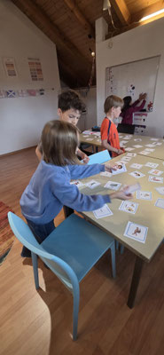 Children collaborating on a creative writing and literacy activity at Custom Kids.