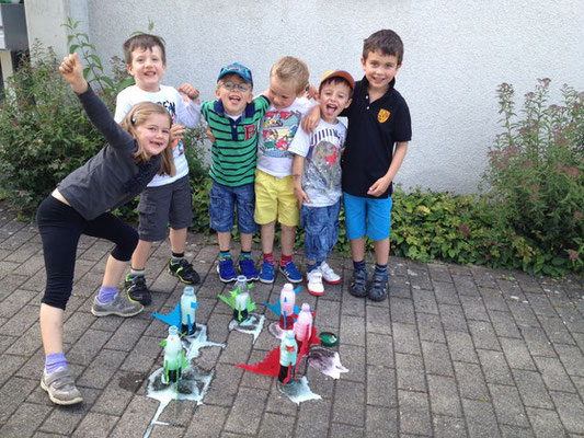 Creative chemistry fun with rocket dinosaurs at Custom Kids Science Club.