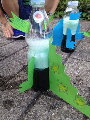 Fizzy explosions with rocket dinosaurs at Custom Kids Science Club.