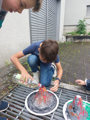 Watching the homemade volcano errupt at Custom Kids Science Club.