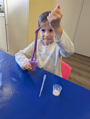 Playing with the stretchy slime made in Science club
