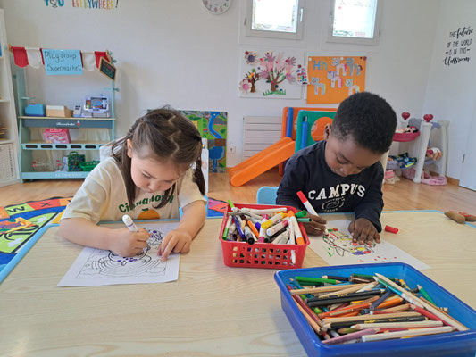 Children building confidence in English through creative learning.