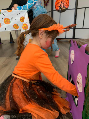 Child taking part in a fun Halloween challenge during a Custom Kids party.