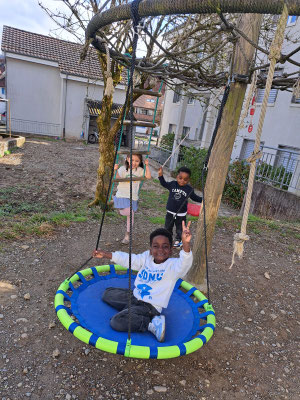 Children playing outdoors during Lunchtime English at Custom Kids.