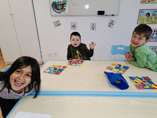Children playing educational games in a small English class at Custom Kids.