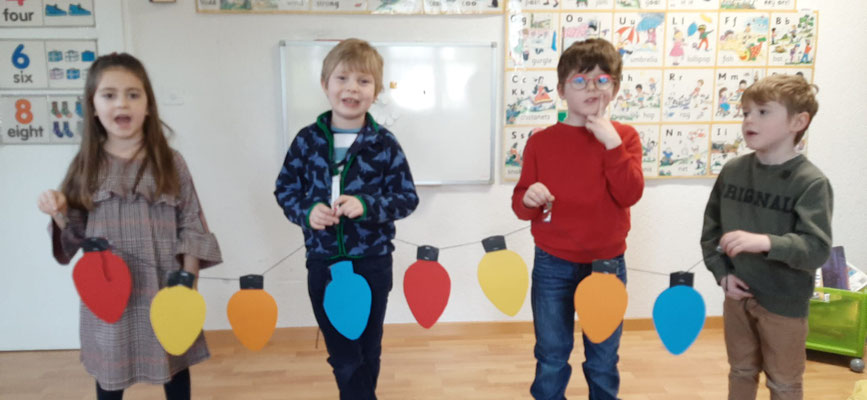 Children developing speaking and vocabulary skills through an interactive classroom activity.