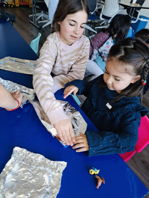 Older children helping younger kids at Science club