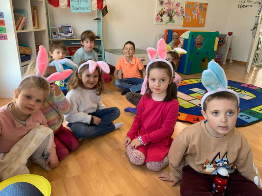 Children wearing bunny ears during a fun Custom Kids Easter party.