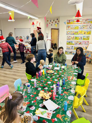 Families enjoying Christmas crafts, games, and festive activities.Children enjoying Christmas crafts, games, and festive activities.