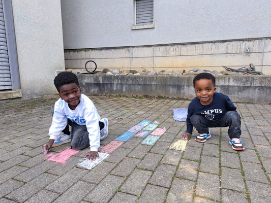 Children practising English outdoors through fun games and movement.