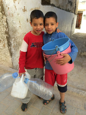Boys, collecting water, Morocco