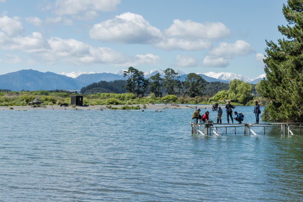 A TV team interviews a river fisherman